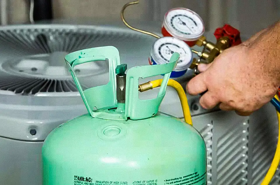 A licensed HVAC technician from Empire Heating & Air checks the refrigerant level on an AC