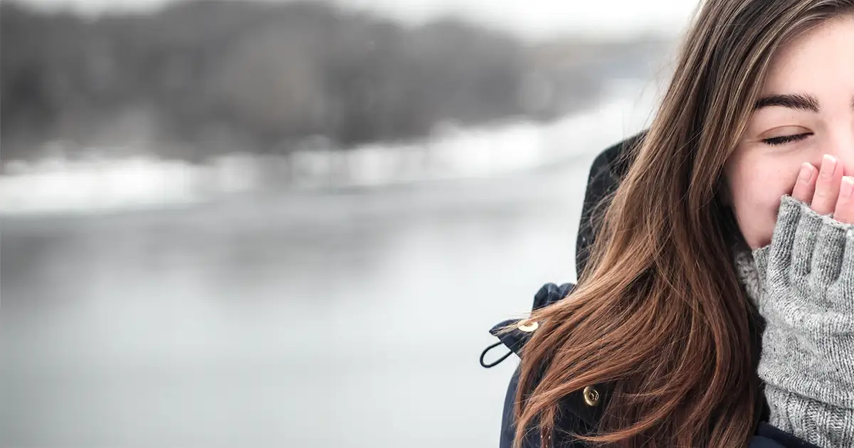 Young woman bundled up in the cold.