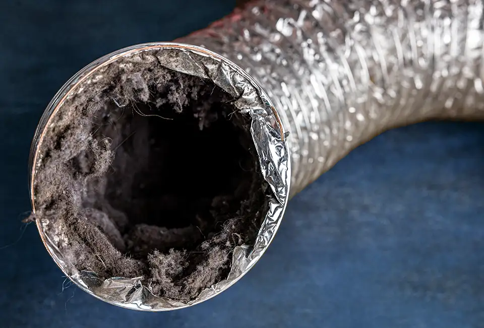 A dryer vent that is clogged with lint and debris.